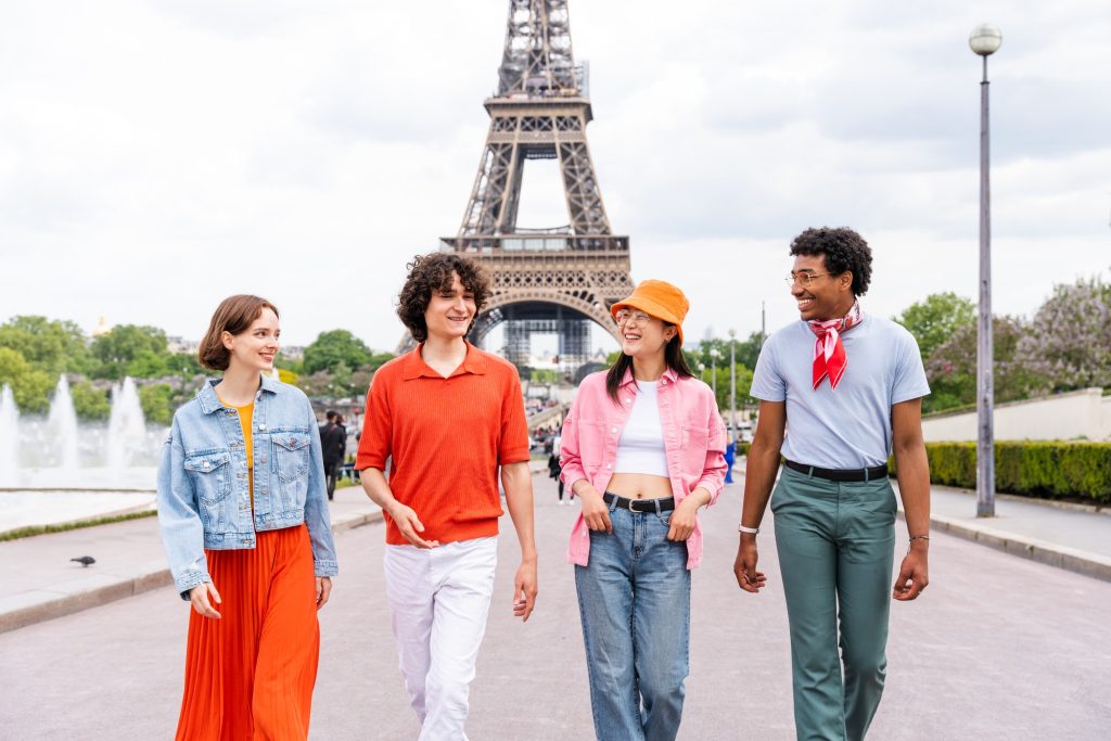Group of young happy friends visiting Paris and Eiffel Tower